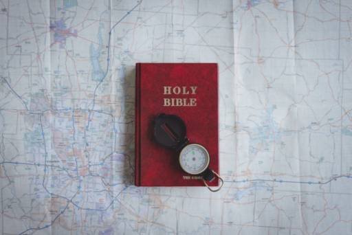 compass on a bible and map