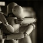 wooden figurines hugging