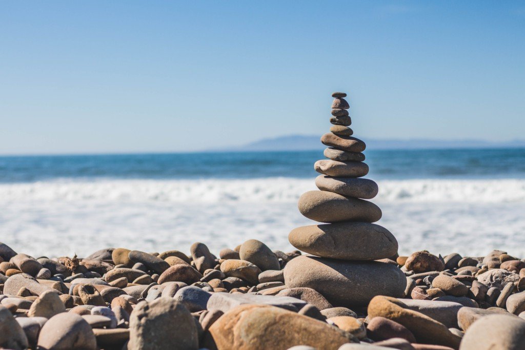 a pyramid of stones at the shore