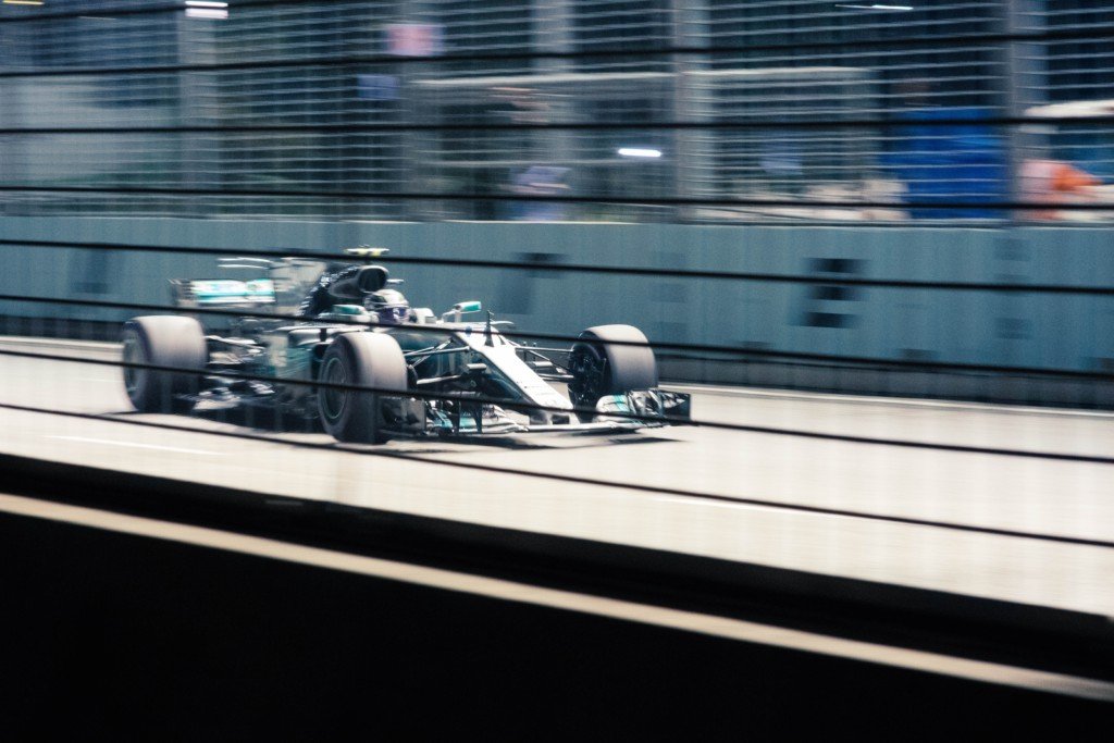 green mercedes f1 car on grey track (Photo by CHUTTERSNAP on Unsplash) 