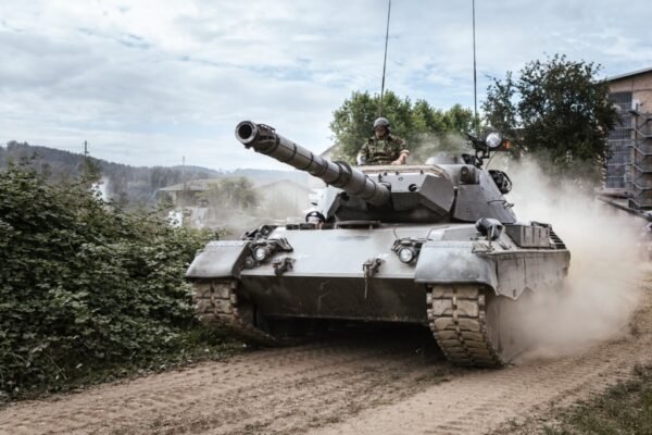 military tank moving through a town