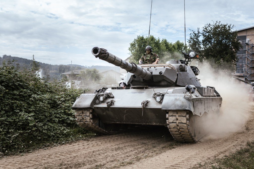 military tank moving through a town
Photo by Kevin Schmid on Unsplash