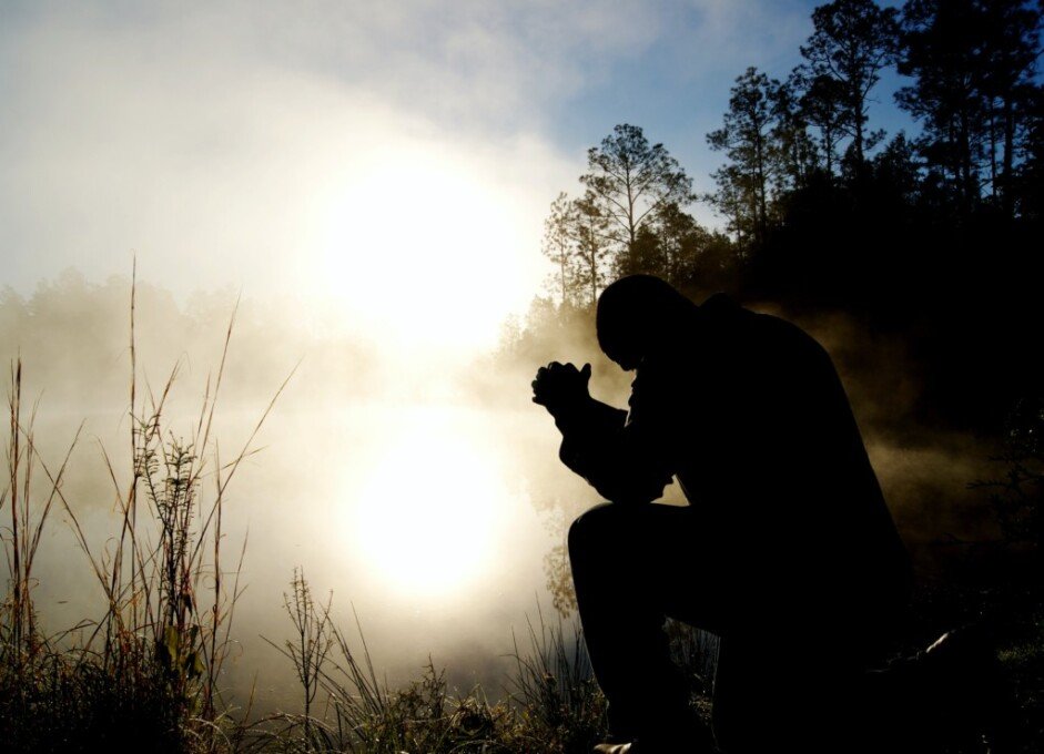 Photo of Man on his knees in a prayer posture by Aaron Burden on Unsplash